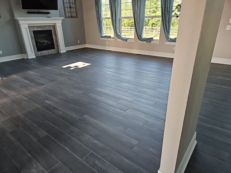 Dark wood-look plank flooring in a living room with a fireplace