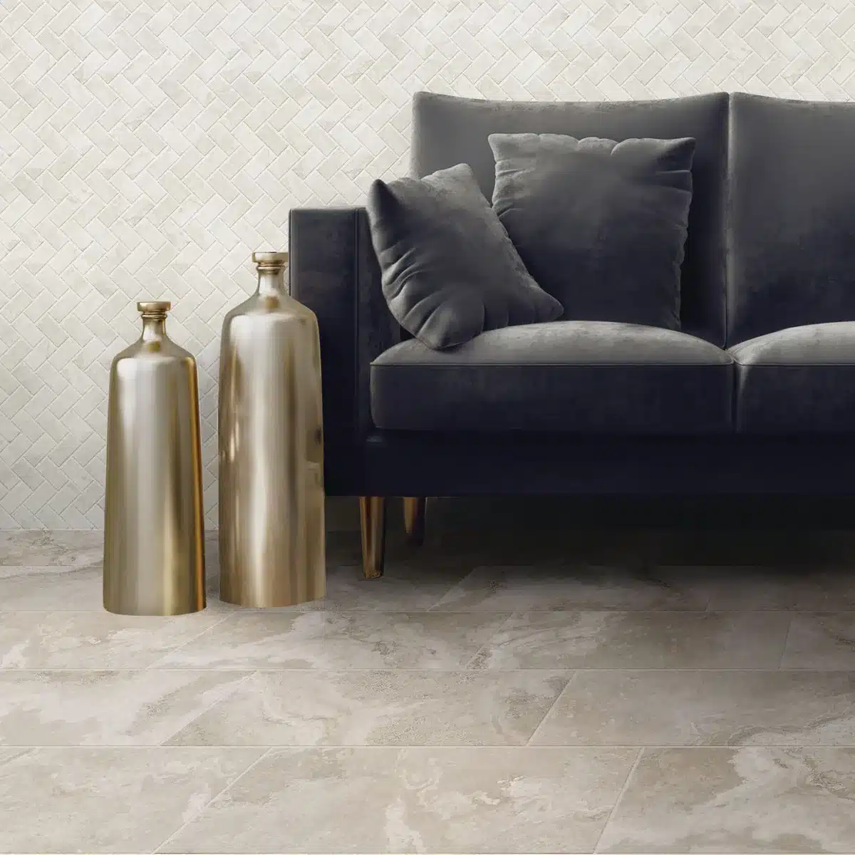 Daltile Archaia Atlas Grey porcelain floor with Relic White herringbone ceramic mosaic behind a dark sofa in a manufacturer scene
