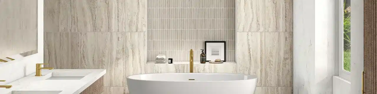 Daltile Calligo Almond travertine-look tile and a coordinating mosaic inset behind a bathtub in a manufacturer bathroom scene