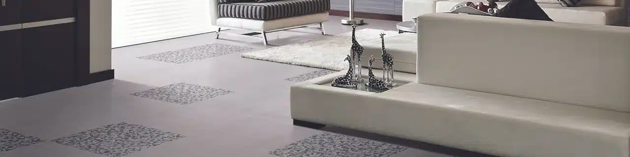 Daltile Fabric Art fabric-look porcelain floor with geometric accents beside white seating in a manufacturer living room scene