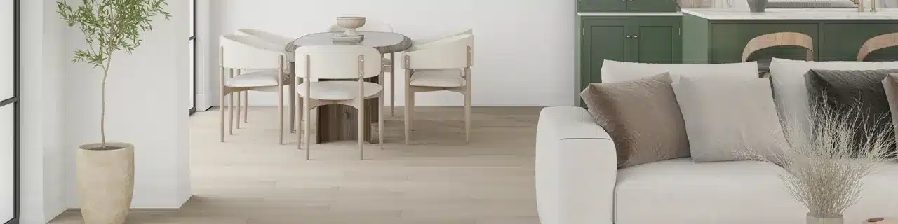 Daltile Halstatt Cottage wood-look luxury vinyl plank beneath a dining table beside a white sofa and green kitchen cabinets in a manufacturer scene