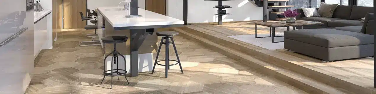 Daltile Limestone Chenille White hexagon flooring around a kitchen island in a manufacturer open-plan living room scene