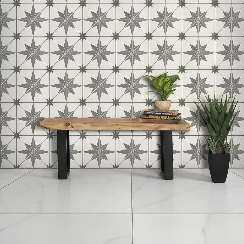 Daltile Memoir Jewel Black patterned ceramic wall tile behind a wood bench and plants in a manufacturer interior scene