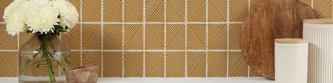 Daltile Revalia Remix dimensional ceramic mosaic on a kitchen backsplash in a manufacturer room scene