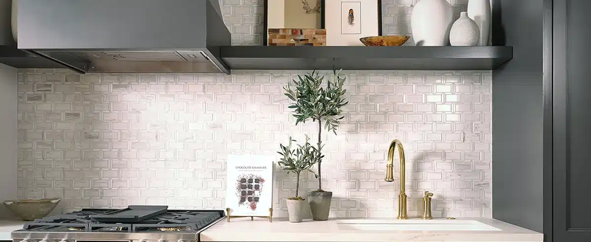 MSI Angora Framework polished marble backsplash behind a cooktop and gold faucet in a manufacturer kitchen scene