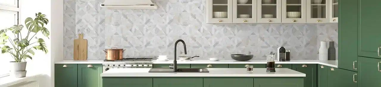 MSI Athena Gold geometric marble backsplash above green kitchen cabinets in a manufacturer room scene