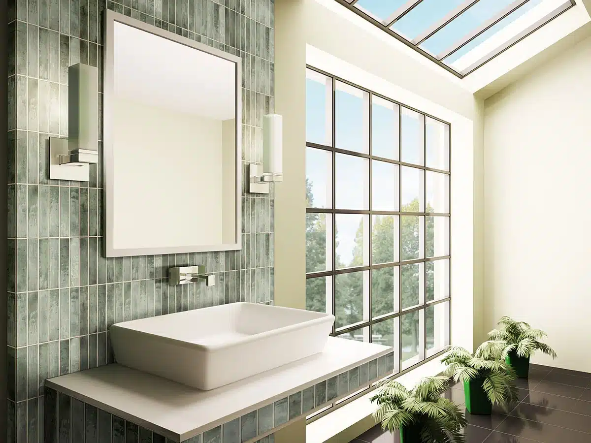 MSI Stella Emerald glossy ceramic tile installed vertically around a bathroom mirror and vessel sink in a manufacturer scene